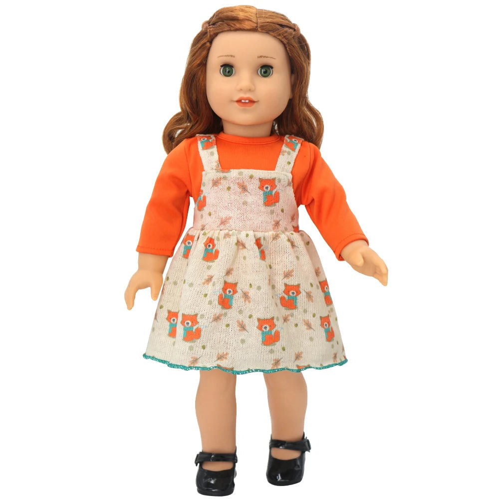 Doll wearing an orange shirt and patterned dress with fox design on a white background